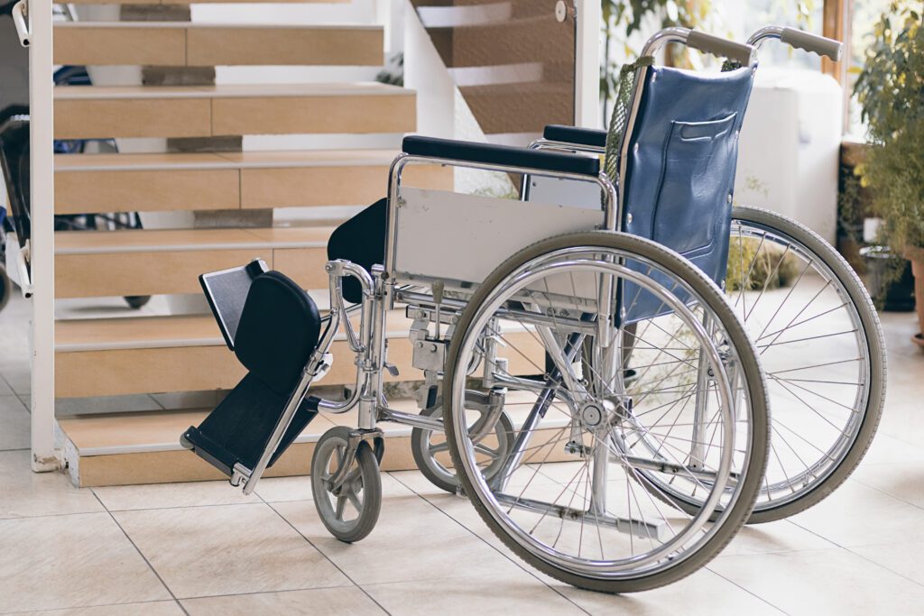 A Wheelchair on the Floor Near Stairs inside Home
