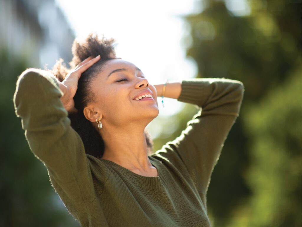 A Woman in Green Dress Relaxing in Park, Wellness Designed Homes