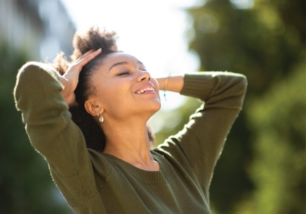 A Woman in Green Dress Relaxing in Park, Wellness Designed Homes